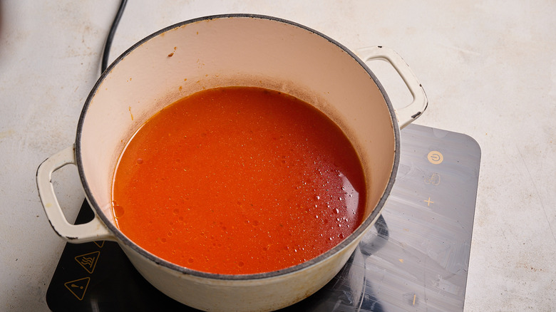 simmering tomato and water in a pot