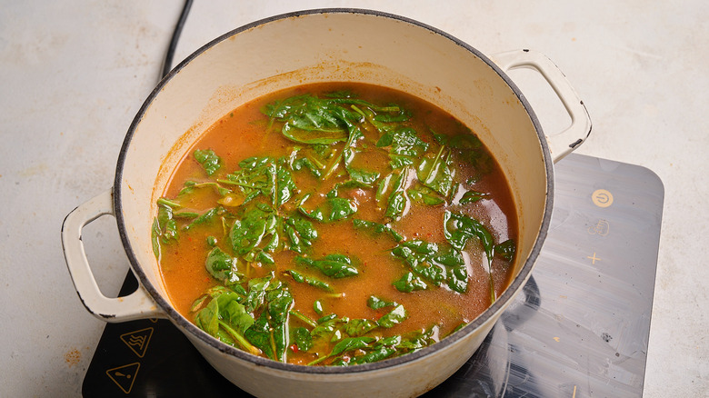 cooking spinach in a pot