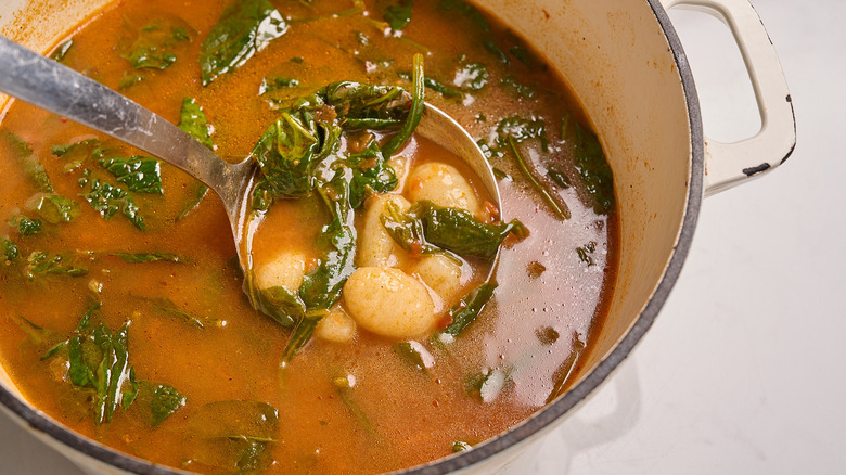ladling soup out of pot