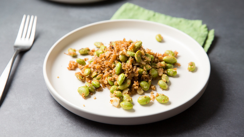 sauteed edamame served on table