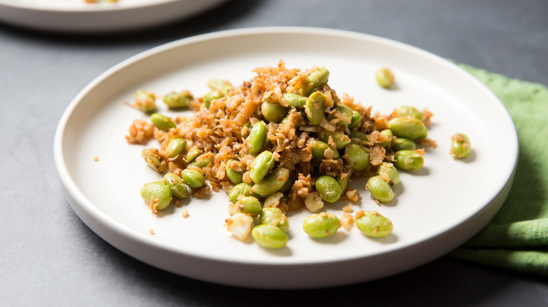 sauteed edamame served on table