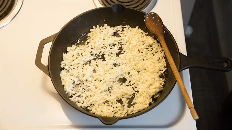 riced cauliflower cooking in pan