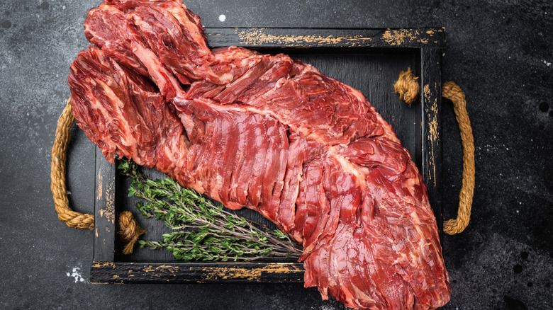 Raw hanger steak on wooden board