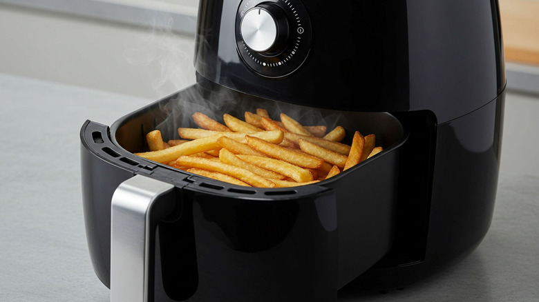 french fries steaming in an air fryer