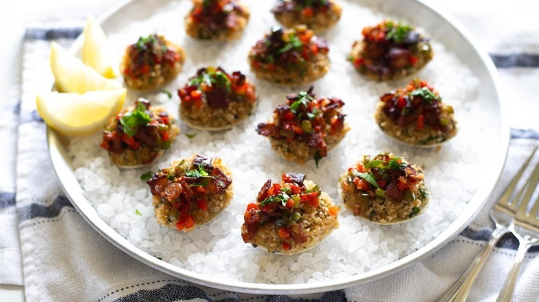 Baked clams on plate with layer of rock salt underneath