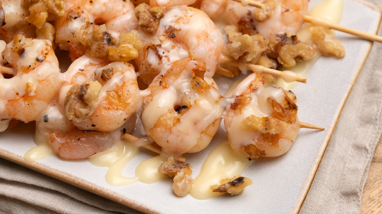 Creamy honey walnut shrimp skewers on serving platter