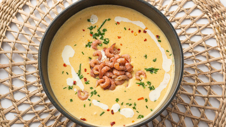 Bowl of creamy shrimp bisque with fresh chive garnish