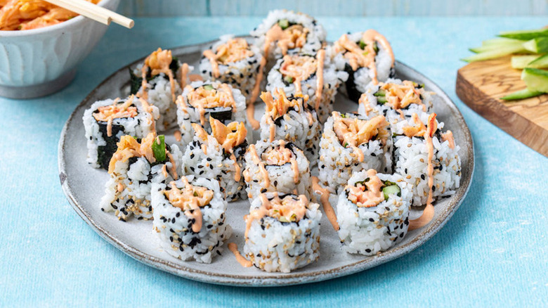 Crab sushi rolls on plate, drizzled with spicy mayo