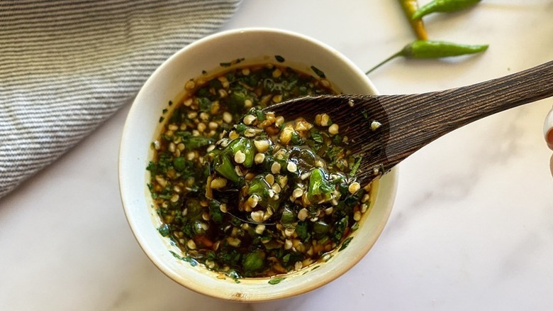 Spooning bang bang sauce from bowl