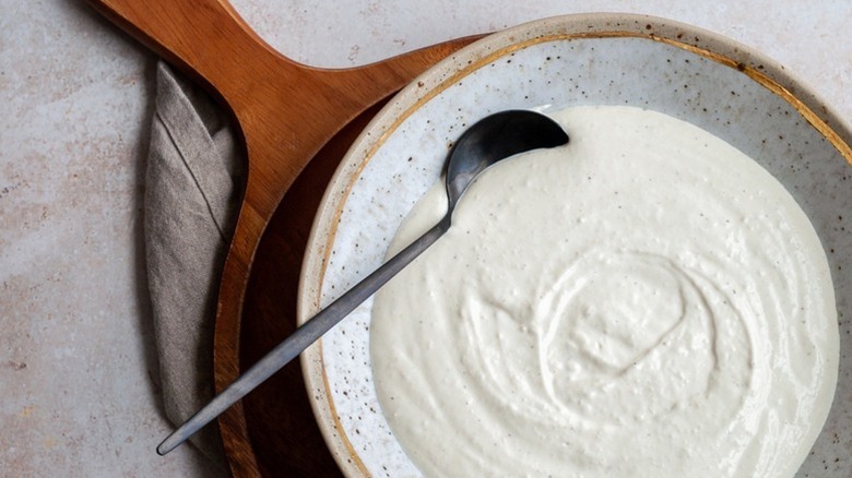 Spoon of creamy horseradish sauce with spoon