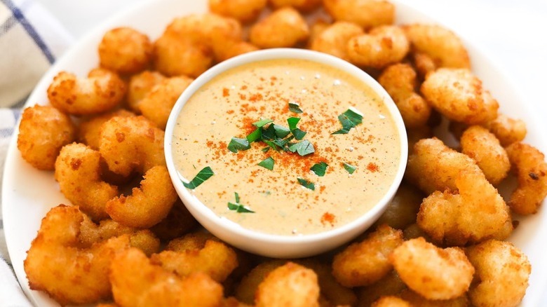 Bowl of remoulade sauce on plate with crispy fried shrimp