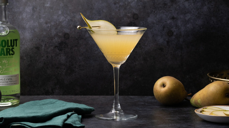 Elderflower and pear martini, garnished with skewered pear slice
