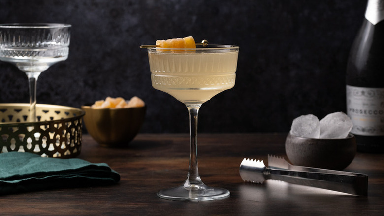 Rhubarb ginger cocktail garnished with skewered crystallized ginger