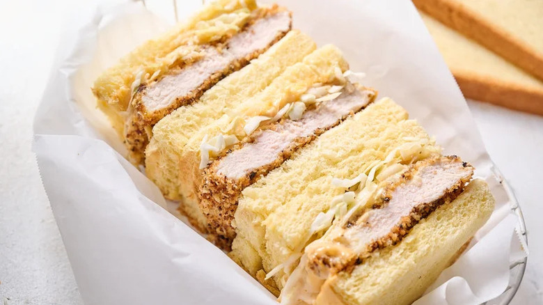 Baked Chicken Katsu Sandwich in wire basket with paper