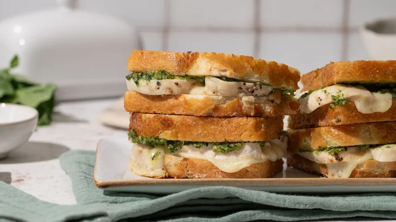 Chicken and Broccoli Pesto Grilled Cheese Sandwich stacked on white plate