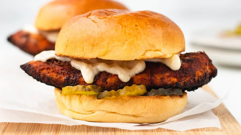 Copycat Popeyes Blackened Chicken Sandwich on parchment paper