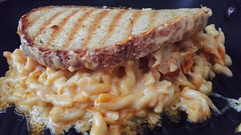 Grilled Buffalo Mac and Cheese Sandwich on black pan