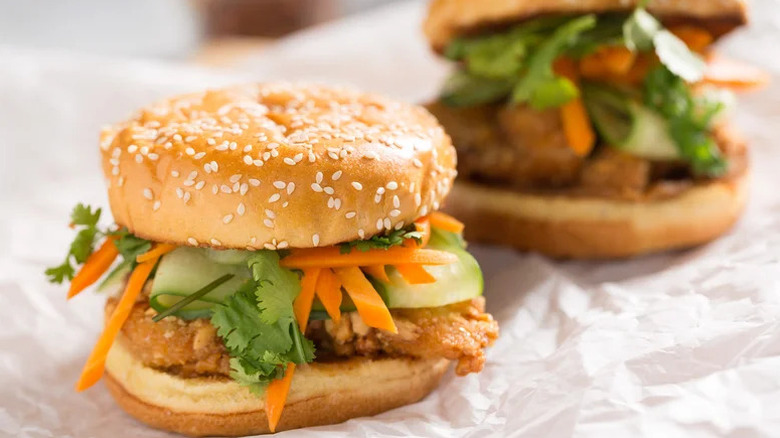 Satay-Inspired Peanut-Crusted Chicken Sandwiches on parchment paper