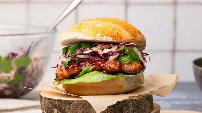Teriyaki Chicken Sandwich with Asian-Inspired Slaw on parchment paper