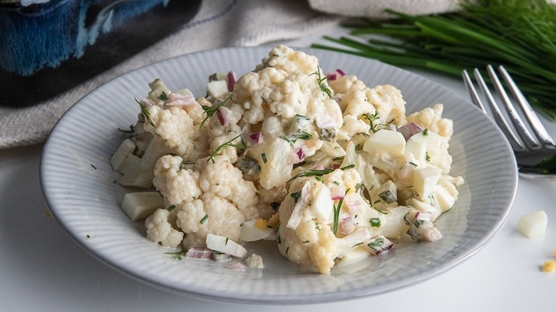 Plate of creamy cauliflower "potato" salad with fresh dill
