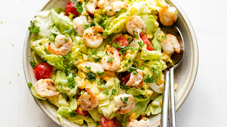 Bowl of grilled shrimp salad with lettuce and tomato