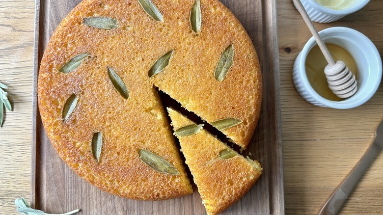 Sliced honey sage skillet cornbread on wooden board