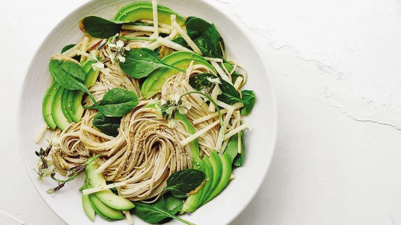 Avocado, Tahini, and Soba Noodle Salad in white bowl on white surface