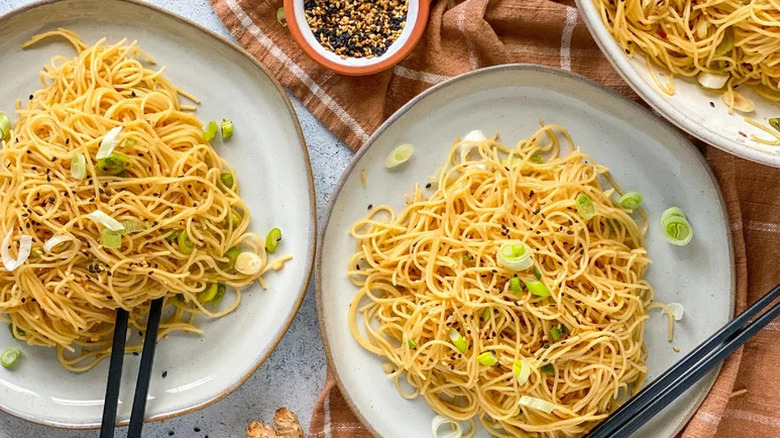 Ginger Sesame Noodles on white plate with chopsticks