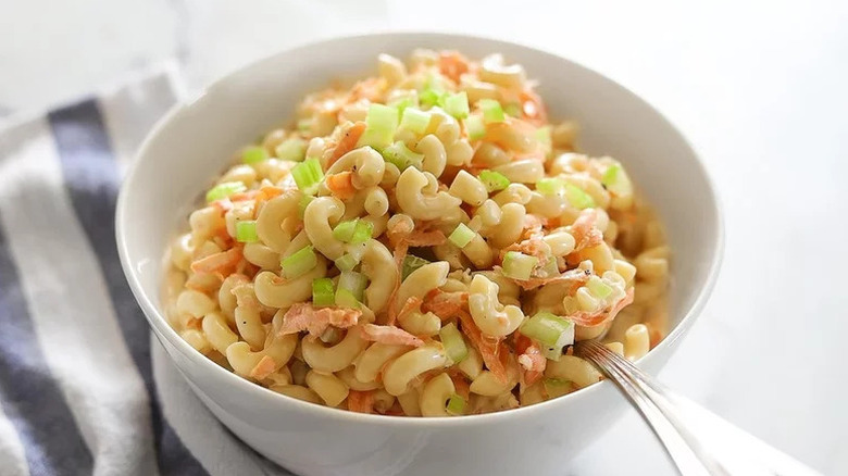 Hawaiian Macaroni Salad in white bowl on blue and white towel