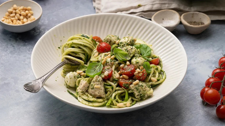 Pesto Chicken and Zucchini Noodle Salad in large textured white bowl