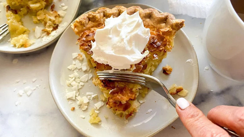 Best Coconut Custard Pie on plate with metal fork