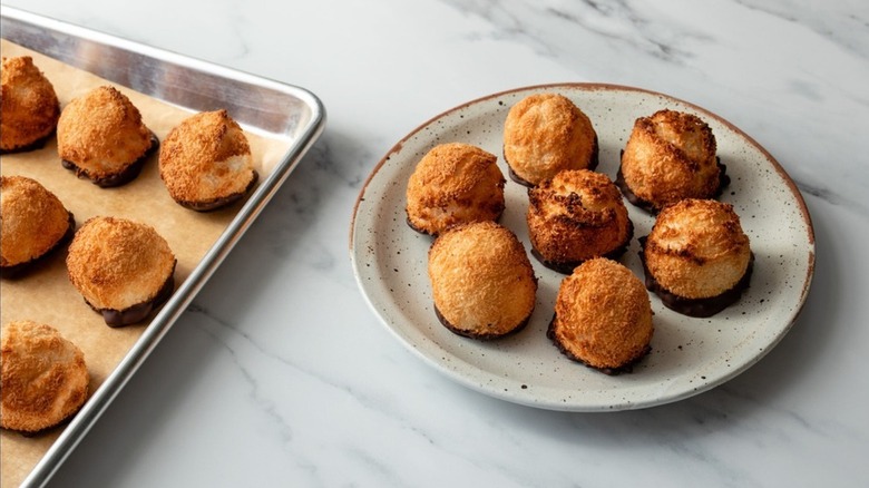 Chocolate-Dipped Macaroons on baking tray and white plate