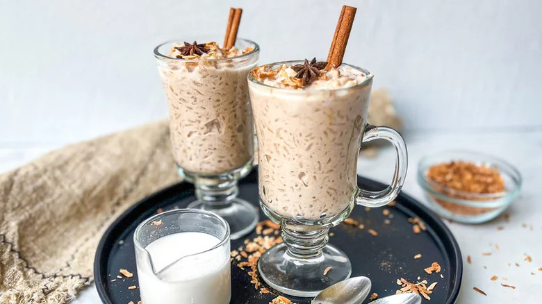 Coconut Chai Rice Pudding in glass mugs on black tray