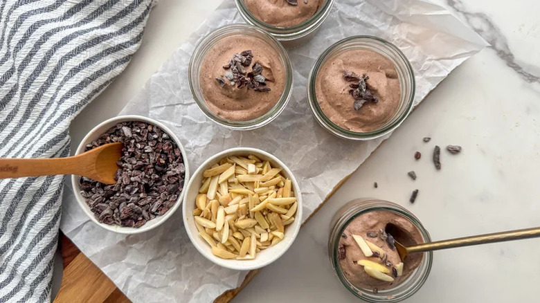 Keto Chocolate Mousse in glass jars with toppings