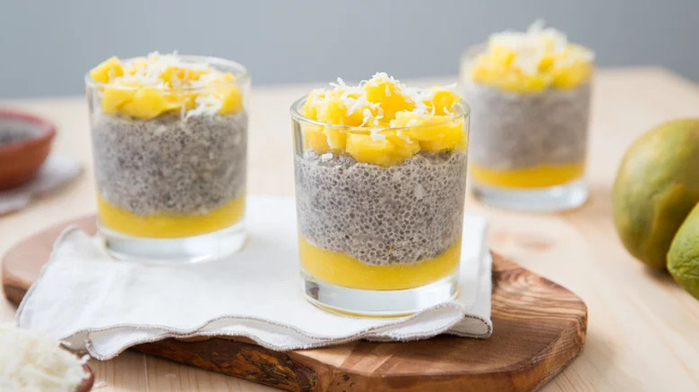Mango Coconut Chia Seed Pudding in glasses on wooden board