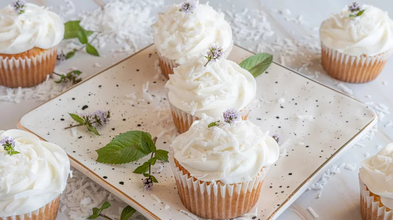 Moist Coconut Cupcakes arranged on square white plate