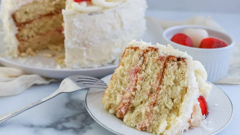 Strawberry, Coconut, and Lychee Layer Cake on white plate