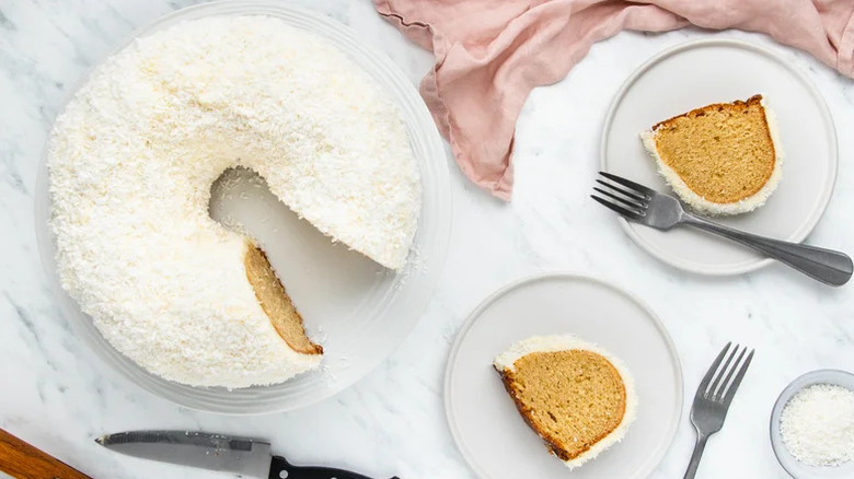 White Chocolate Coconut Bundt Cake on white plates with forks