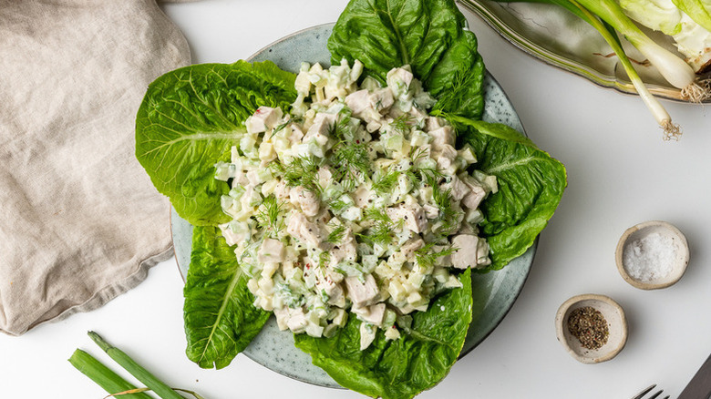 Creamy chicken salad served over large lettuce leaves