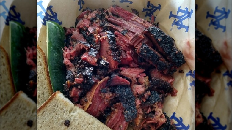 Burnt ends pastrami with bread on Mets-branded paper