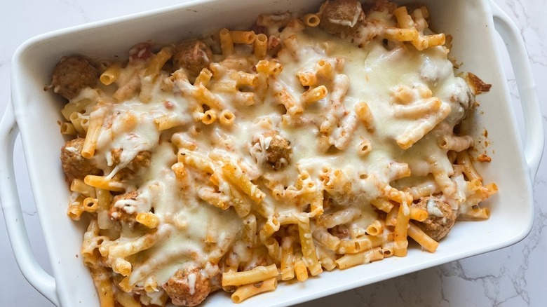 Cheesy meatball pasta bake in baking dish