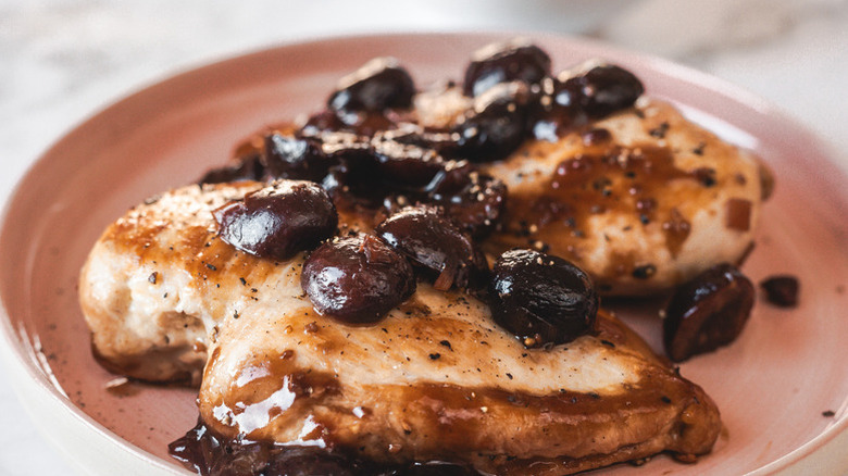 Chicken breasts on plate, topped with cherry balsamic sauce