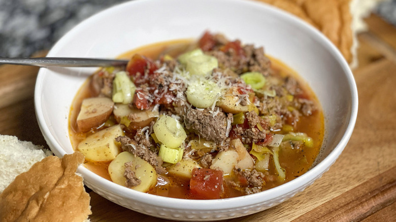 Beef, leek, and potato stew in white bowl