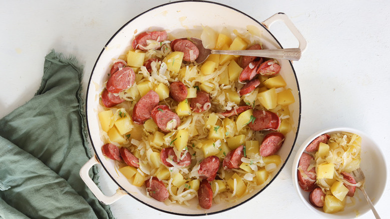 Kielbasa, potato, and sauerkraut dinner in casserole pot
