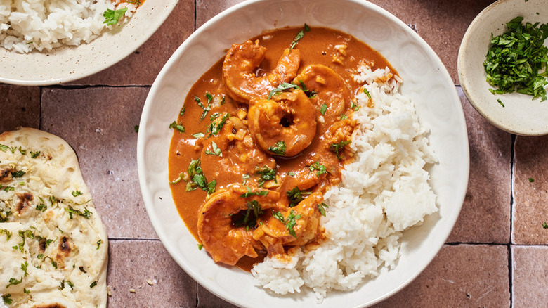 Bowl of shrimp tikka masala with rice and a fresh cilantro garnish