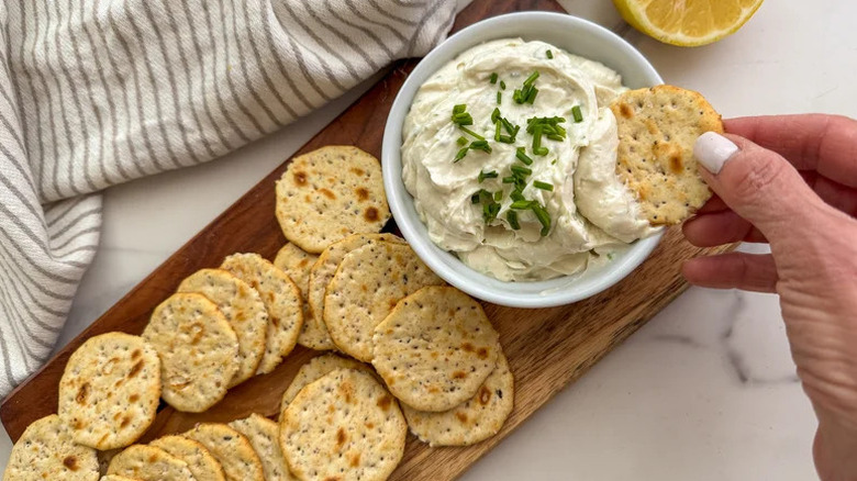 dipping crackers in chese dip