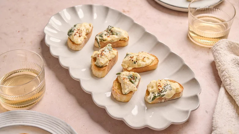 spinach artichoke dip crostini on plate