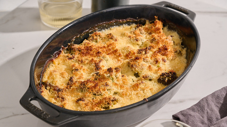 Cheesy broccoli au gratin in black baking dish