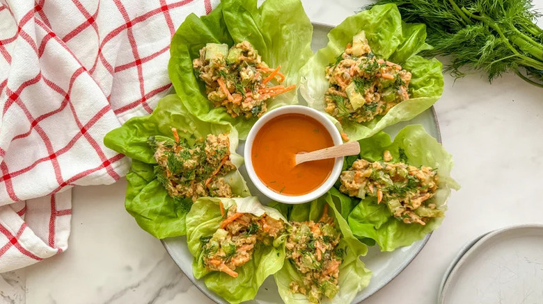 Buffalo Chickpea Lettuce Wraps on white plate with buffalo sauce