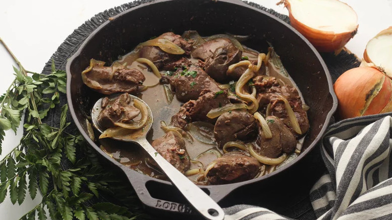 Classic Liver and Onions in black skillet with spoon
